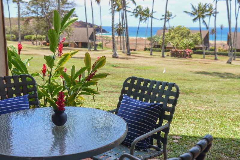 table and chairs on condo lanai with ocean views