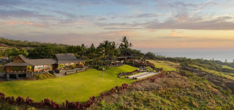 the club at hokulia during a beautiful pastel sunset over the ocean