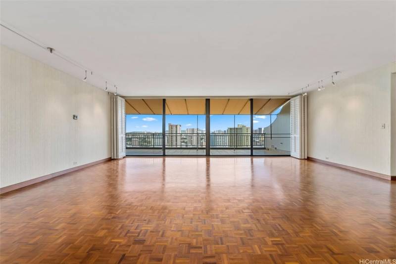 large empty living room with honolulu city views