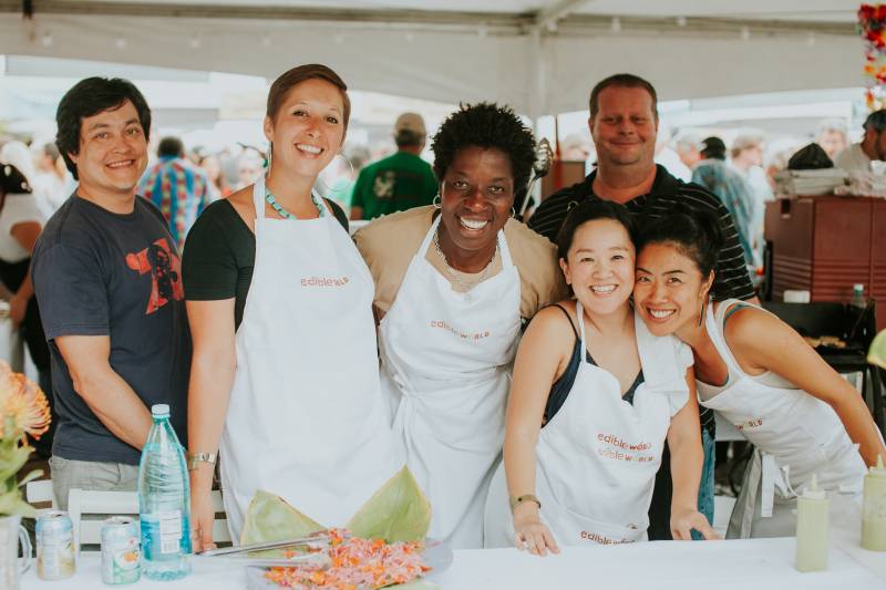 group of peoplewearing aprons pose for photo at big island food and drink festival