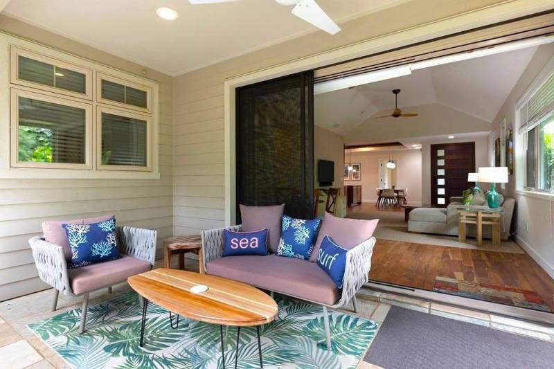 seating area on covered lanai and open sliding doors to condo on big island