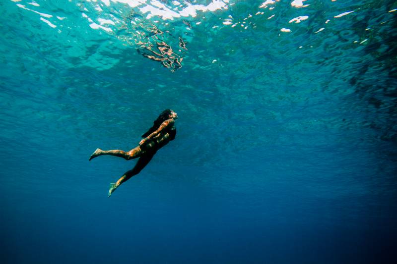 woman freediving about to come to the surface