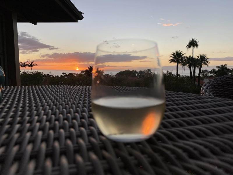 sunset over the ocean through a wine glass
