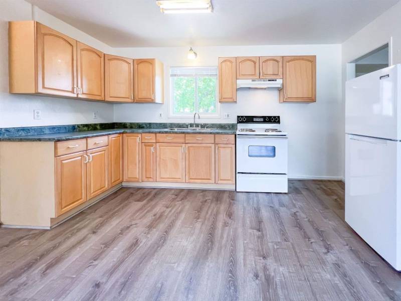 kitchen with vinyl floors and wood cabinets
