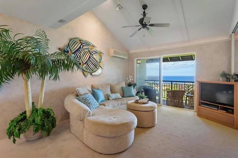 curved couch and sliding door to lanai with ocean view