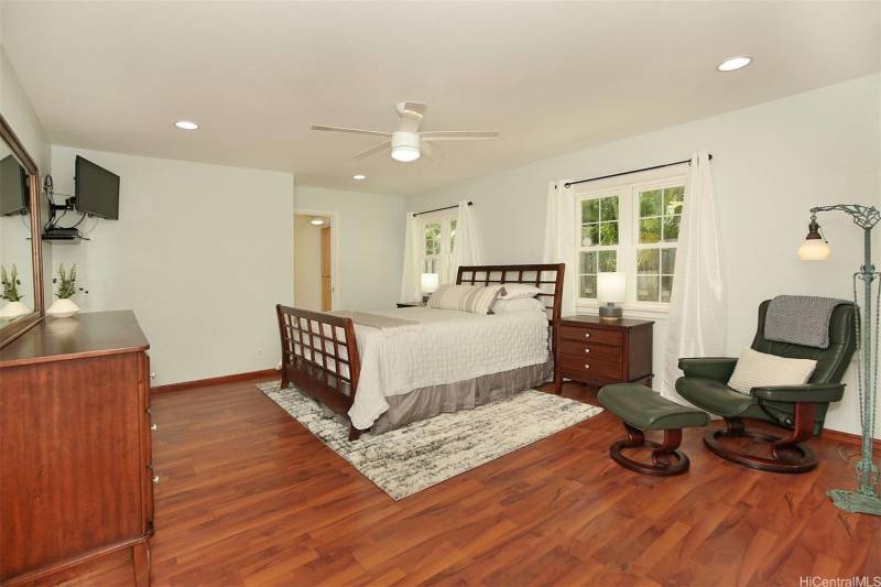 rich wood floors in the large bedroom