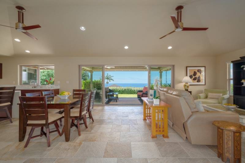 living and dining area with large windows that let in ocean views