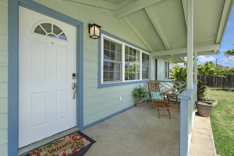 white front door of light blue house