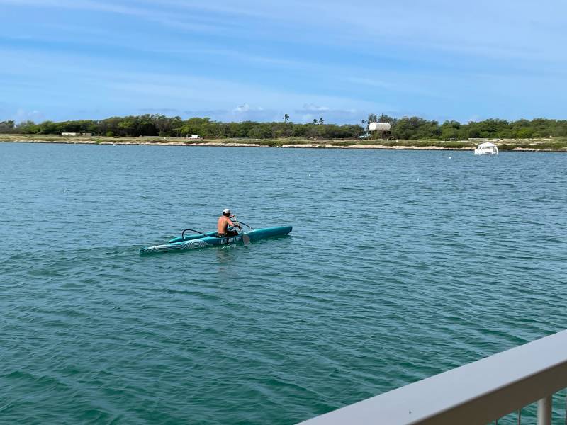 man paddling out in the lagoon