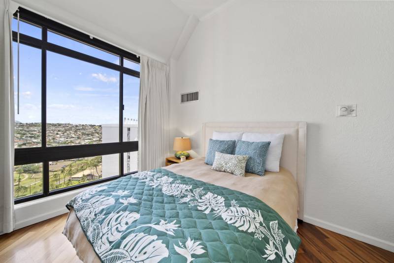 bedroom with large windows and oahu views