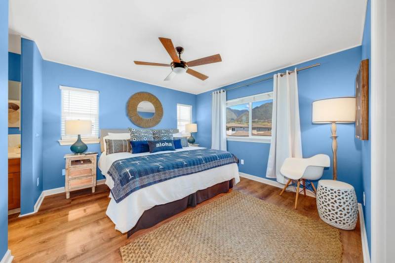 bright blue walls and blue accents on bed in bedroom