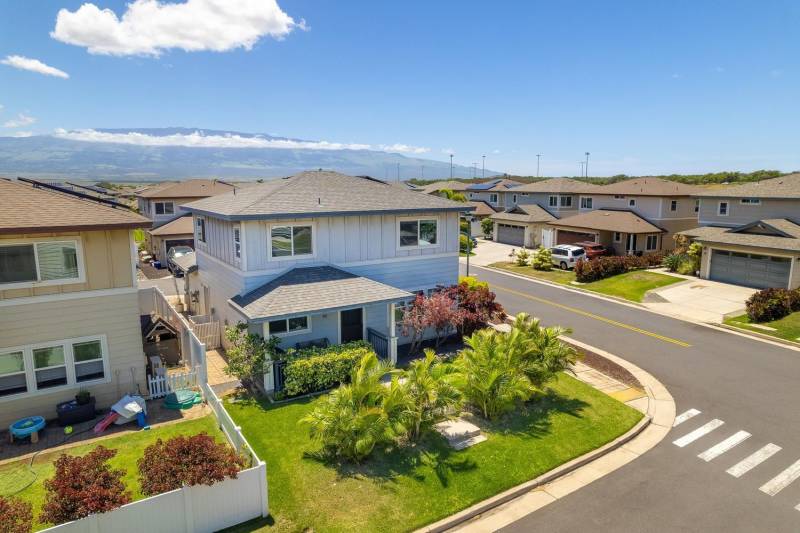 exterior of maui home for sale with unfenced grass yard