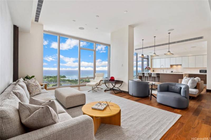 living room in penthouse condo with large windows
