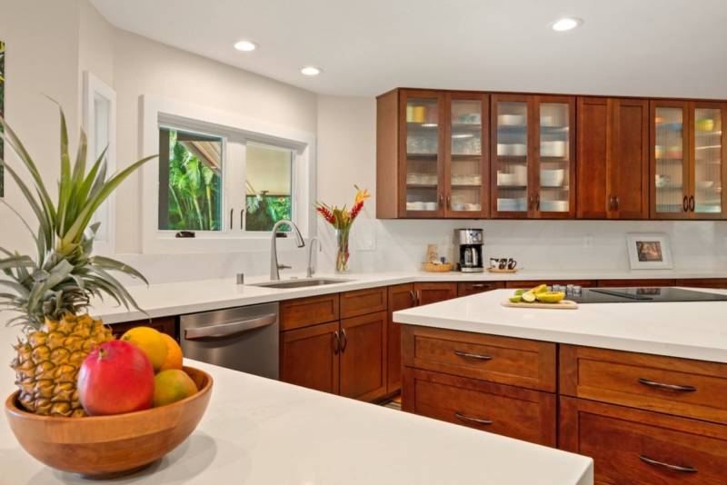 white countertops and wood cabinets in kitchen