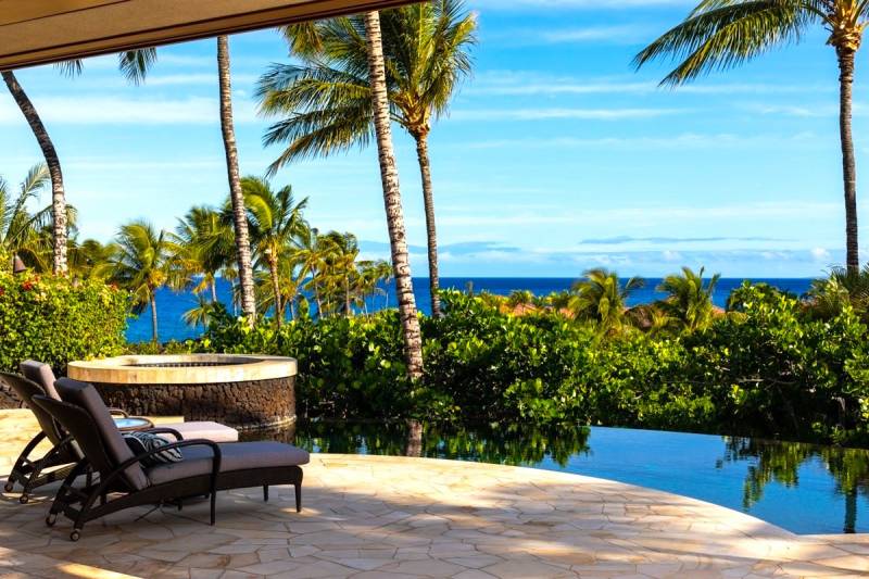 lounge chairs by the pool in hawaii beachfront property