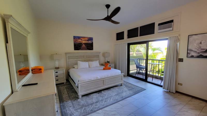 large bedroom with sliding door to lanai