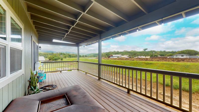 large covered lanai with views of the grass yard