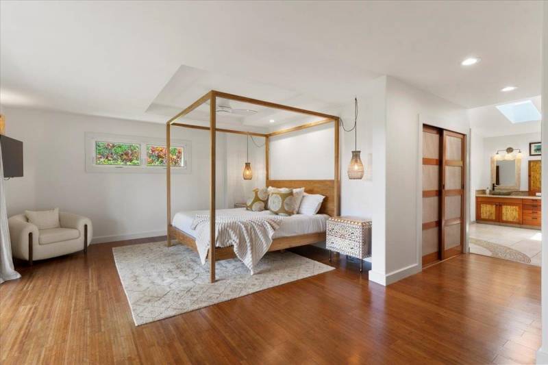 shiny wood floors in bedroom with white rug