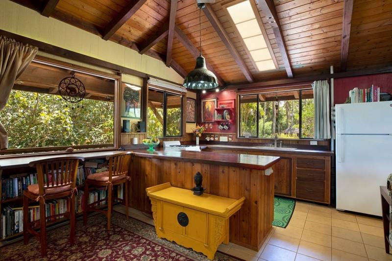 kitchen in big island home with lots of wood accents