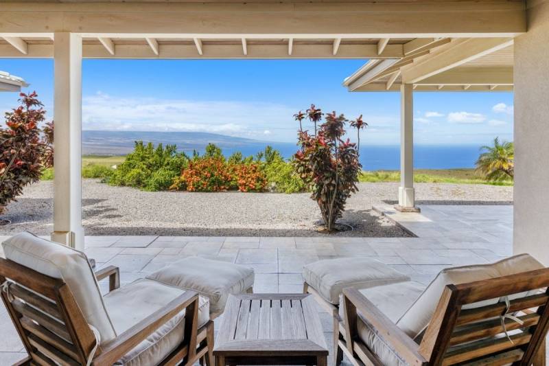 two chairs under covered lanai looking at ocean view