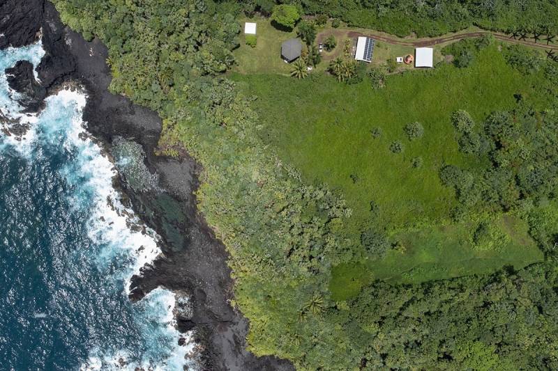 aerial view of home near big island lava rock coastline