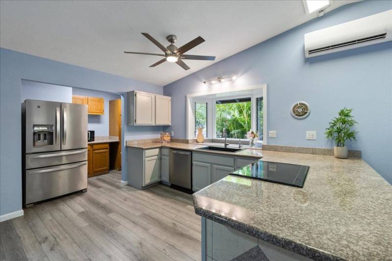 kitchen with light gray cabinets and blue painted walls