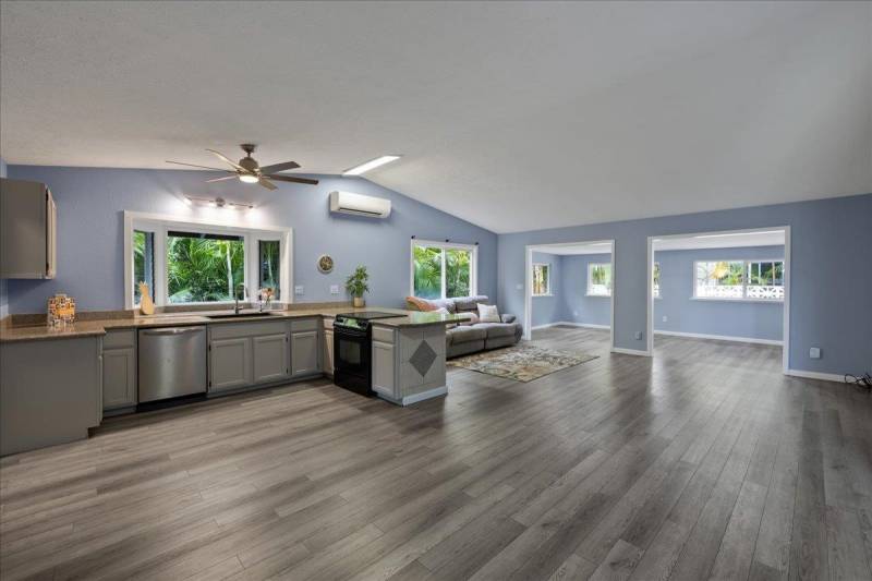 gray vinyl plank flooring and blue walls in kitchen and living space