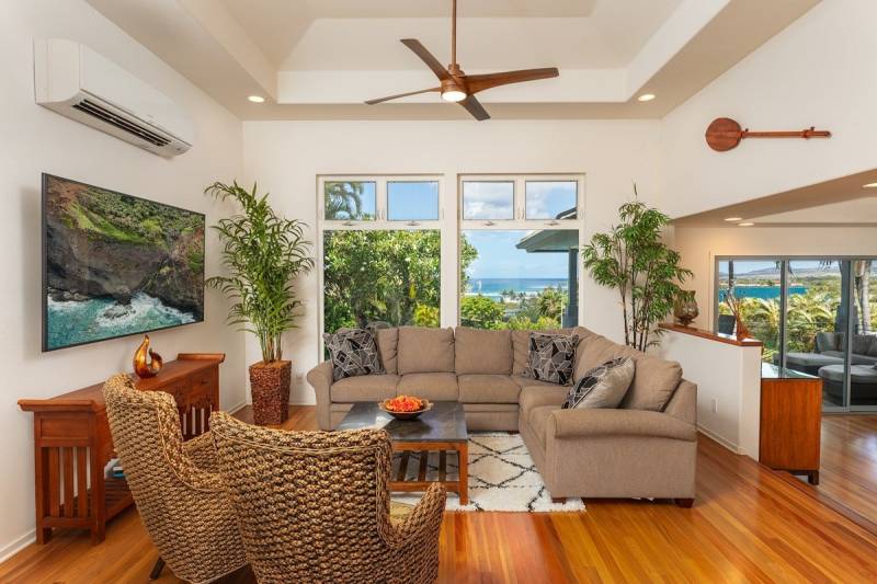 living room with large windows and ocean views on kauai