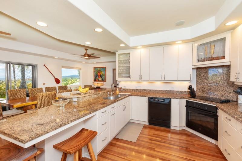 white cabinets and tan stone countertops in kitchen