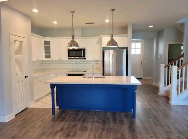 white cabinets and countertops with blue island