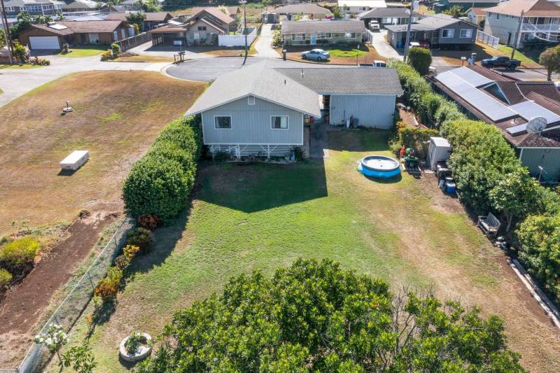 aerial view of pukalani maui home on quarter acre lot with grass yard