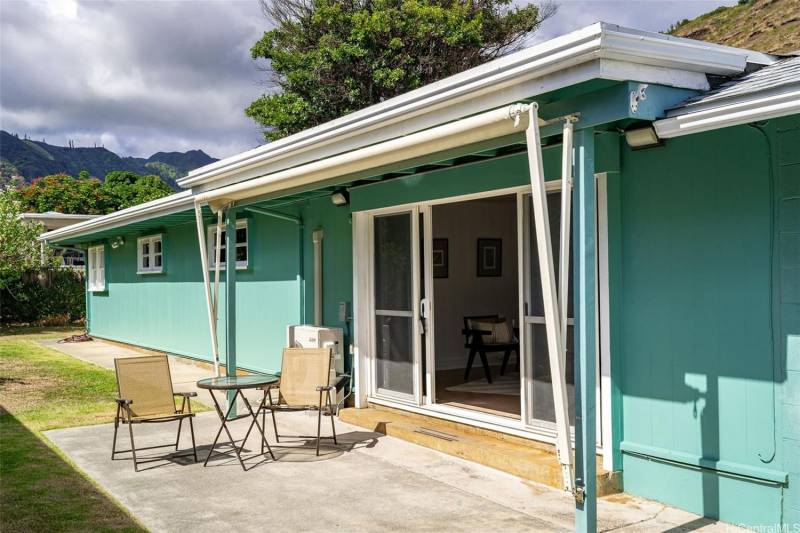 teal colored house with white trim in aina haina oahu