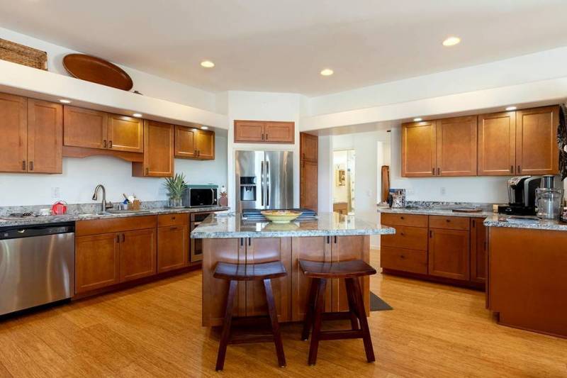 large kitchen with wood floors and wood cabinets