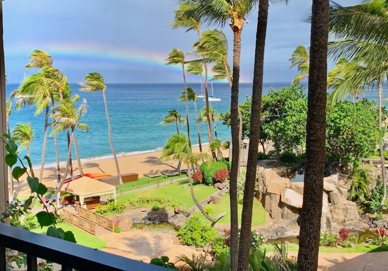 view of rainbow over the ocean from inside kaanapali alii condo