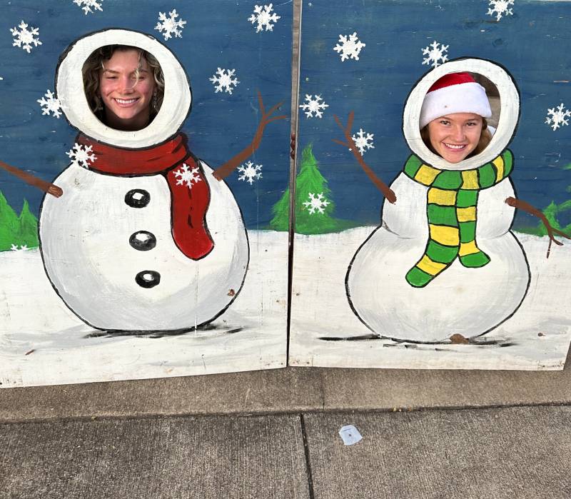 two people pose for photo in snowmen photo op