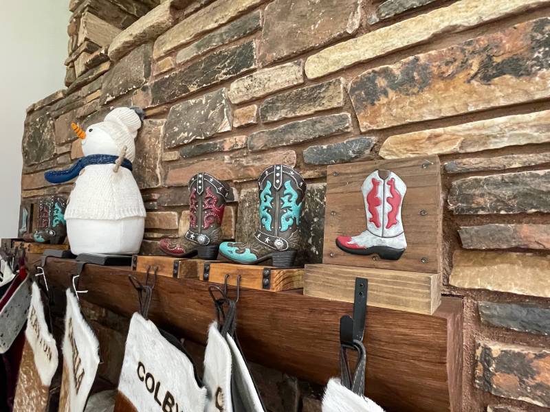 cowboy boot stocking holder on fireplace mantle