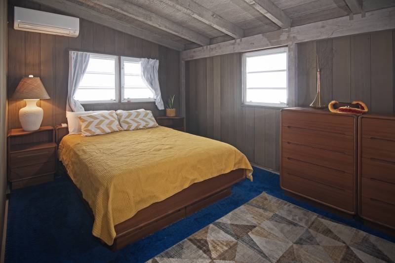 bedroom with wood paneled walls