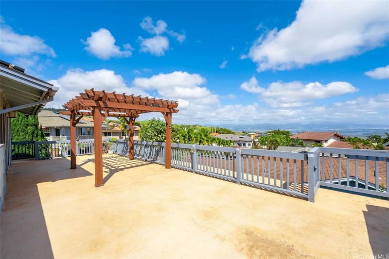 large upper deck with pergola at oahu home