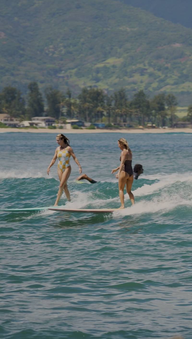 two women surfing on the north shore of oahu