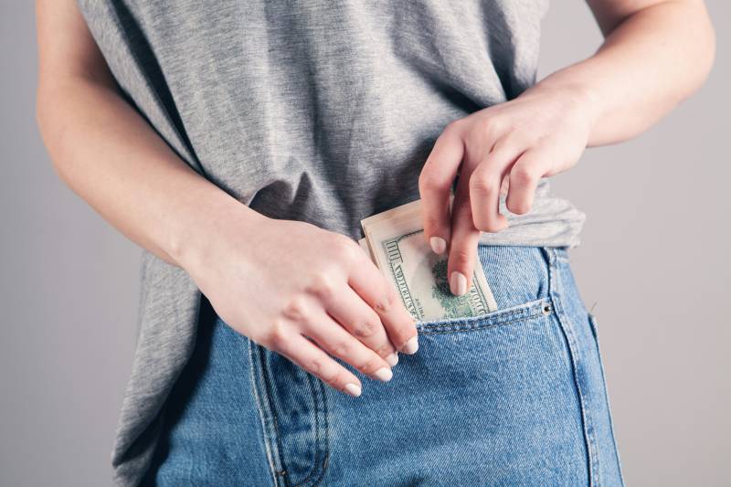 cash money in jeans pocket
