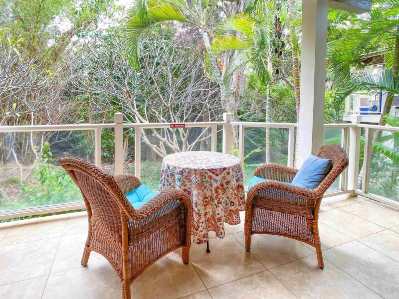 table and two chairs on sitting on covered lanai
