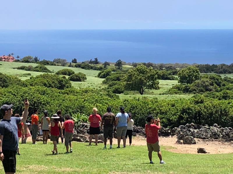people visiting hawaii cultural site