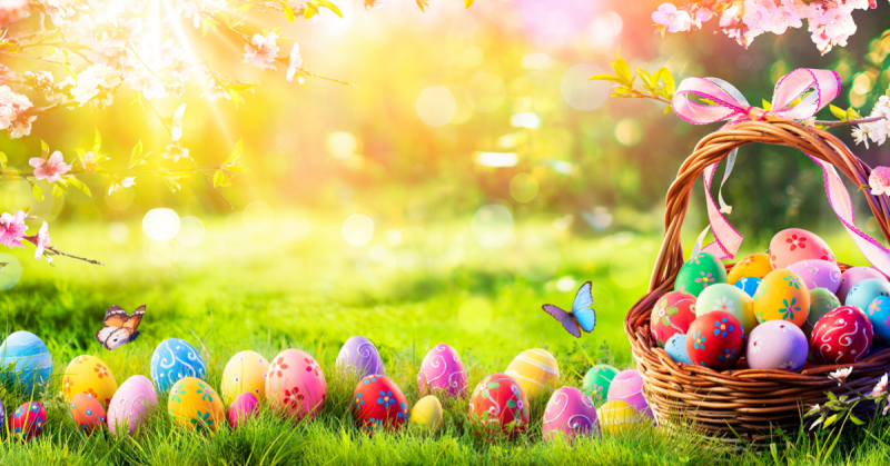 basket of colorful easter eggs on grass