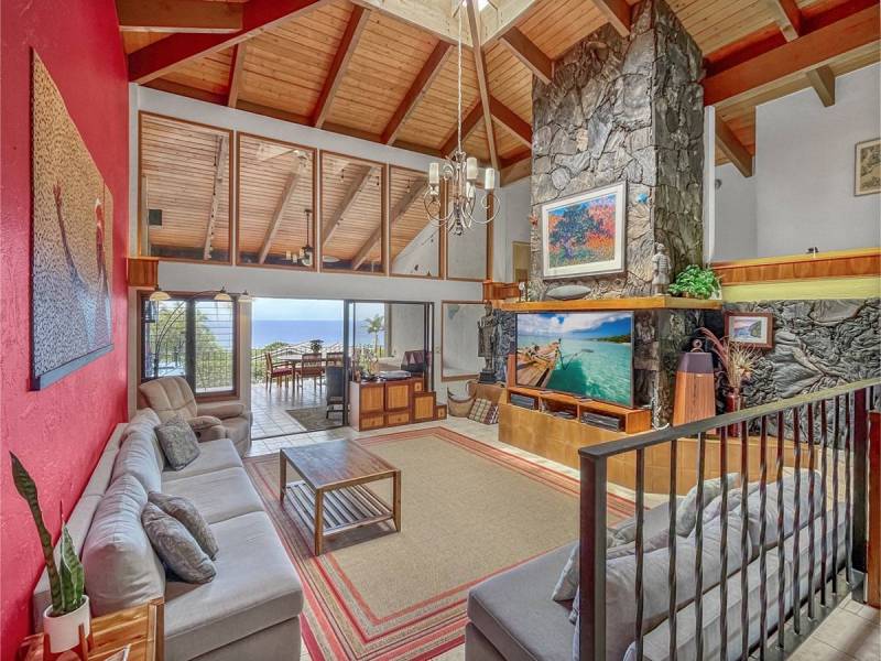 large stone fireplace in living room in kona big island home