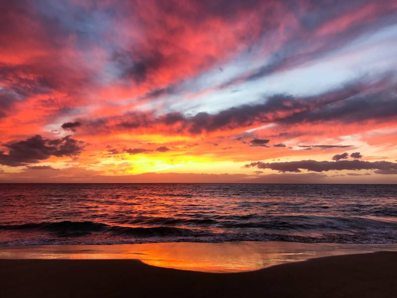 sunset over the ocean in wailea maui