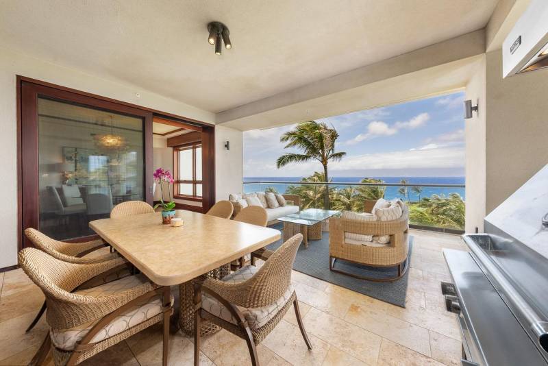 dining table and sofa seating on large ocean view lanai