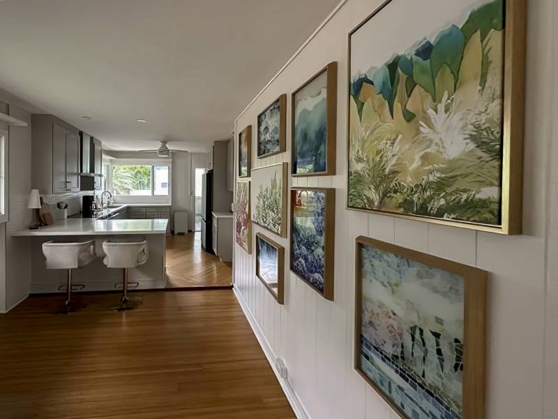 view into kitchen with gallery of art of wall