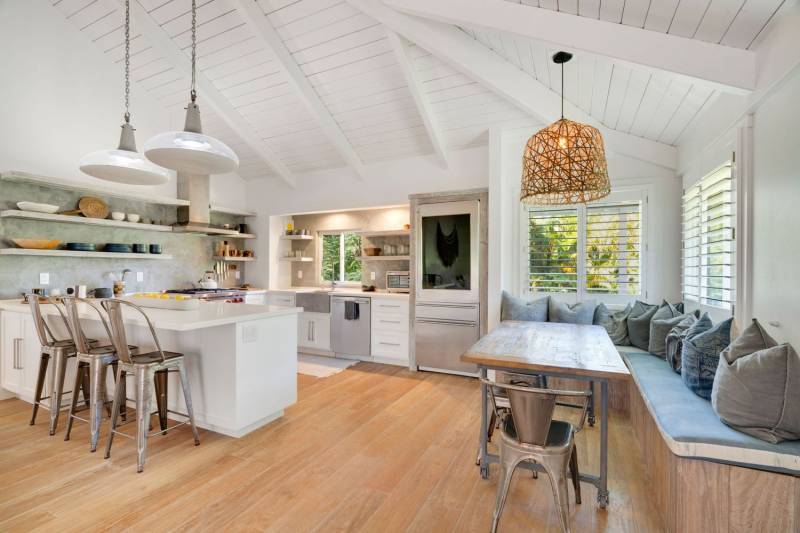 bright kitchen with high ceilings and banquette seating in breakfast nook