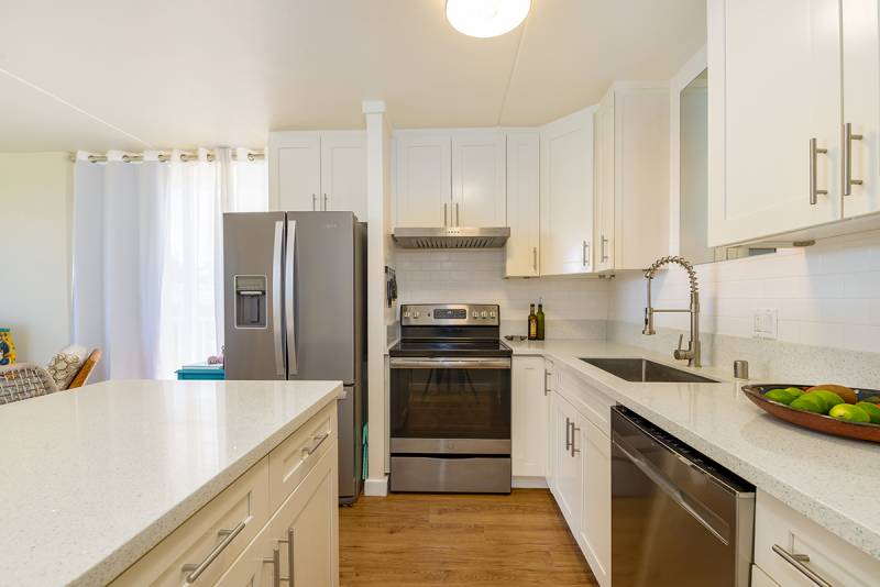 clean white kitchen with stainless steel appliances