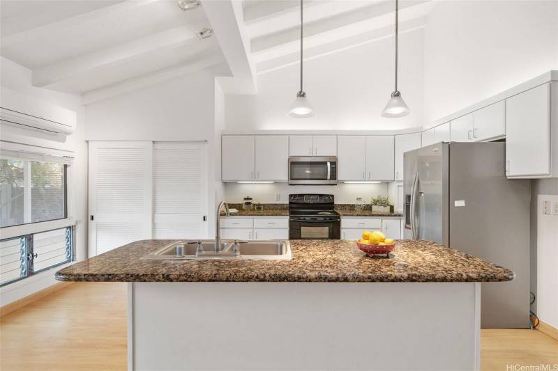 white cabinets and stone countertops in kitchen